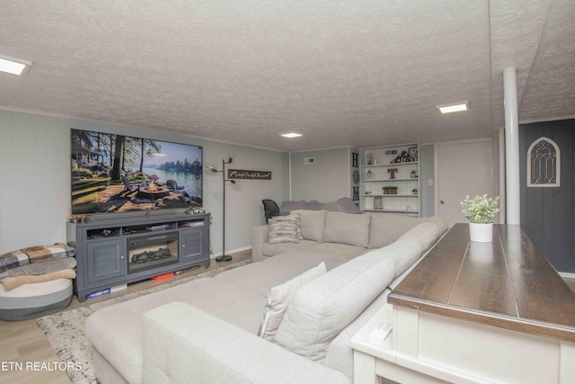 living room with a textured ceiling and wood finished floors