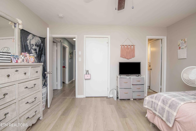 bedroom with a ceiling fan, baseboards, and light wood-type flooring
