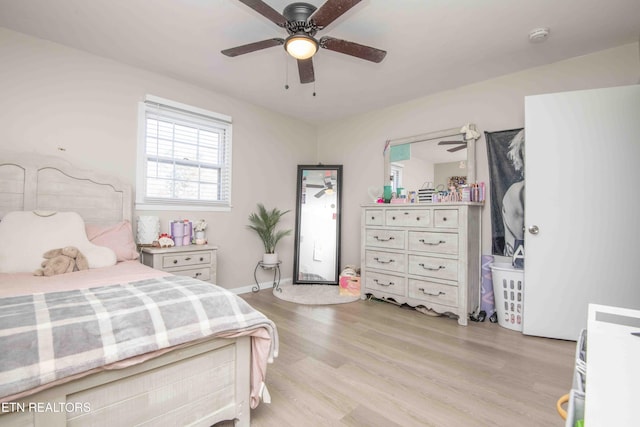 bedroom with light wood-style flooring and ceiling fan
