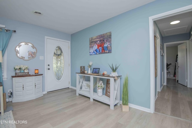 entrance foyer with wood finished floors, baseboards, and visible vents