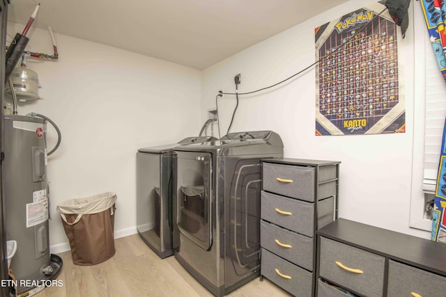 laundry room featuring washing machine and clothes dryer, light wood-type flooring, laundry area, baseboards, and electric water heater
