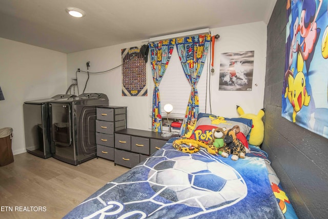 bedroom with washer and clothes dryer and wood finished floors