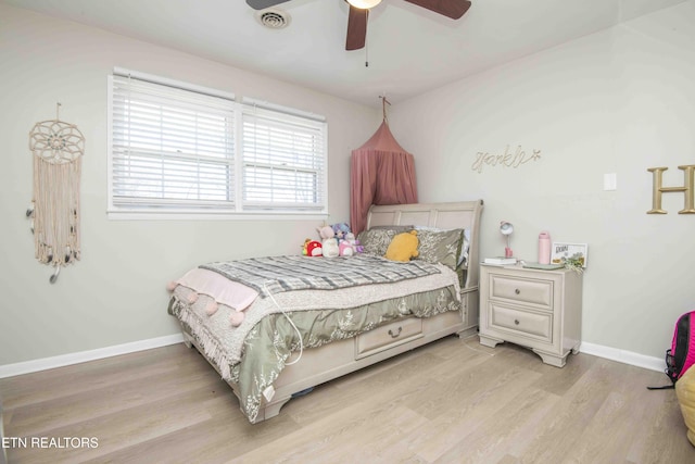 bedroom with baseboards, light wood-style floors, ceiling fan, and visible vents