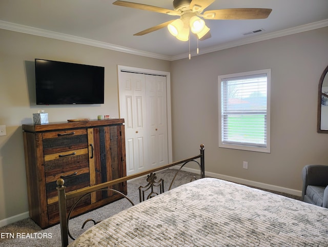 bedroom with a closet, visible vents, baseboards, ornamental molding, and carpet floors