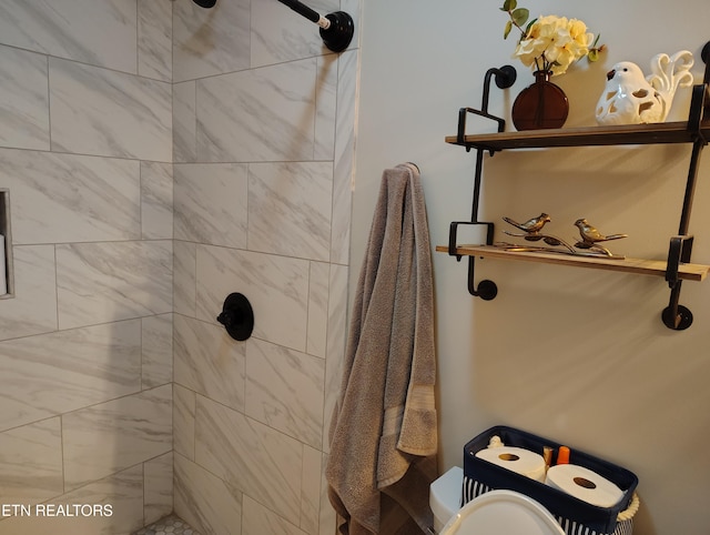 bathroom with tiled shower and toilet