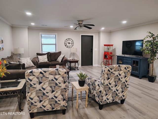 living room with recessed lighting, crown molding, and light wood-style flooring