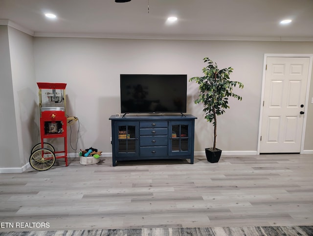 living area with wood finished floors, crown molding, recessed lighting, and baseboards