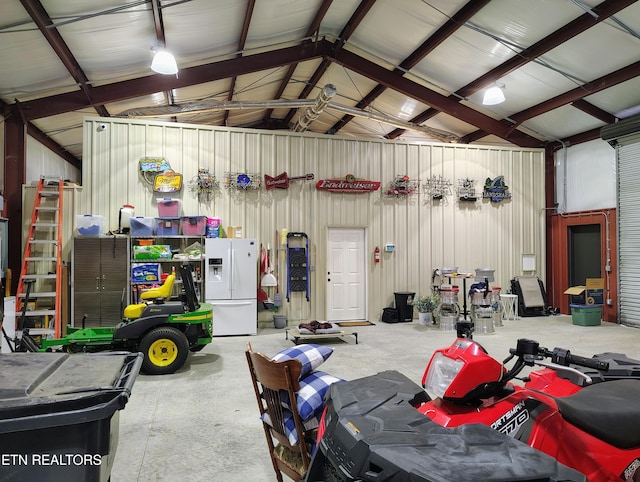 garage with white refrigerator with ice dispenser