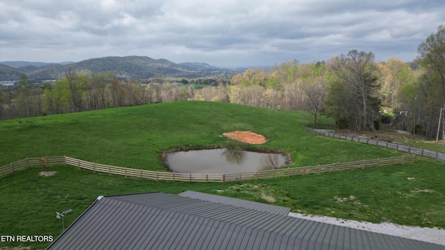 view of yard featuring a mountain view and fence