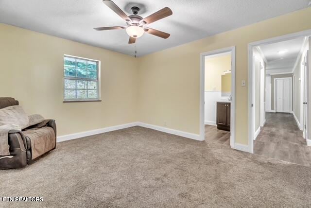 unfurnished room with ceiling fan, baseboards, and carpet floors