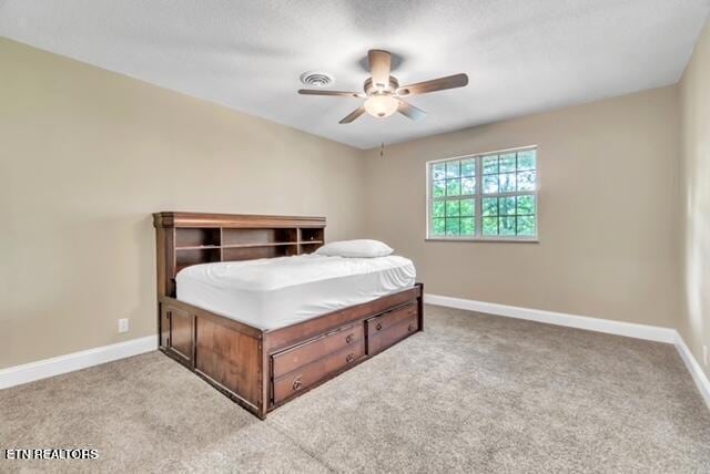 bedroom with light carpet, ceiling fan, and baseboards