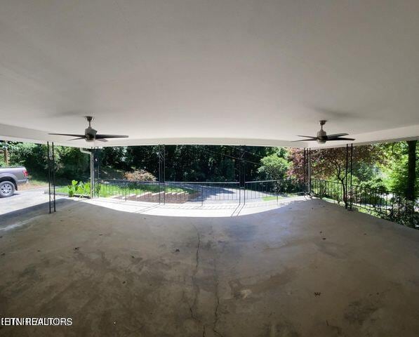 view of patio with fence and a ceiling fan
