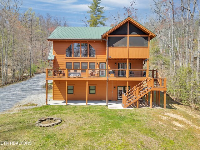 2164 Newt Huff Ln, Sevierville, TN 37862 - back of house featuring a forest view, stairs, a wooden deck, and a yard