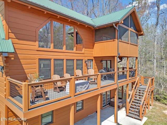 2164 Newt Huff Ln, Sevierville, TN 37862 - back of property with a sunroom, stairway, a patio, metal roof, and a deck