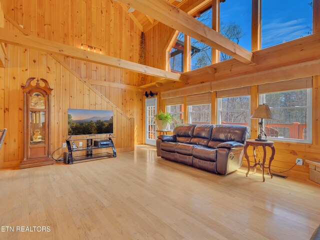 2164 Newt Huff Ln, Sevierville, TN 37862 - living room featuring high vaulted ceiling, wooden walls, and wood finished floors