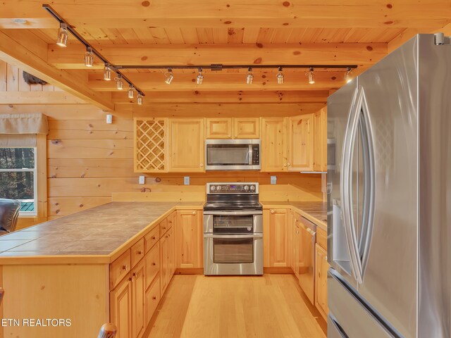 2164 Newt Huff Ln, Sevierville, TN 37862 - kitchen with a peninsula, stainless steel appliances, light wood-style floors, and light brown cabinetry