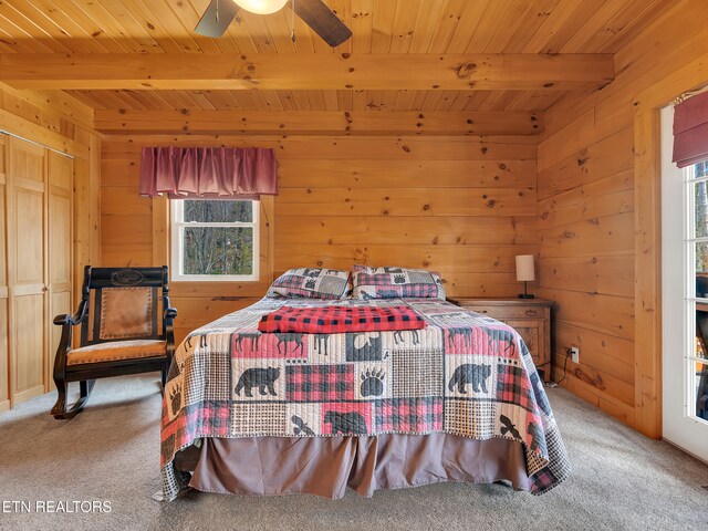 2164 Newt Huff Ln, Sevierville, TN 37862 - carpeted bedroom featuring wood ceiling, wooden walls, multiple windows, and beamed ceiling