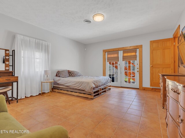 2164 Newt Huff Ln, Sevierville, TN 37862 - bedroom with access to outside, light tile patterned flooring, multiple windows, and a textured ceiling