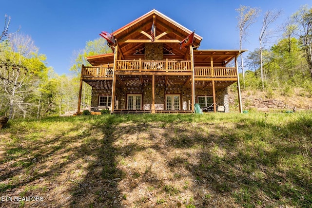 rear view of house featuring a deck and french doors