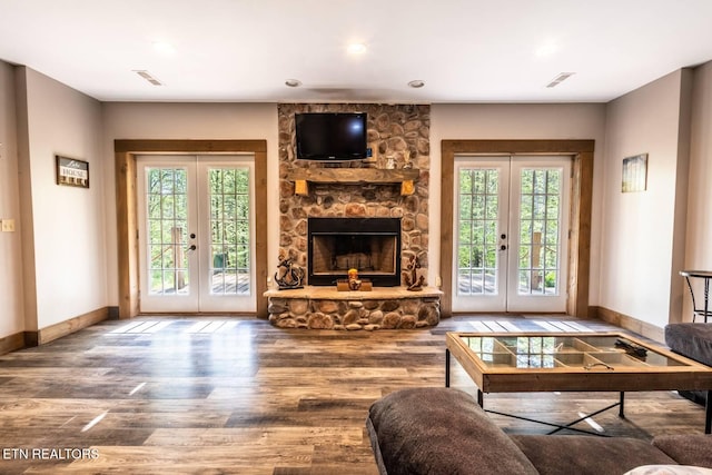 living area with baseboards, french doors, and wood finished floors