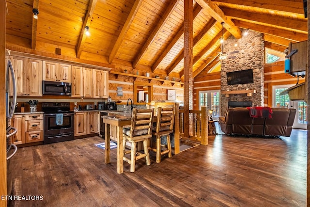 kitchen with a sink, stainless steel microwave, open floor plan, black electric range, and dark wood-type flooring