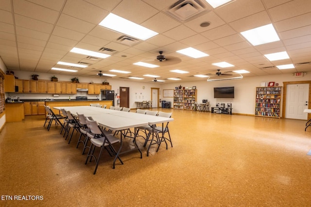 dining space with visible vents, a drop ceiling, and light floors