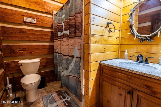 full bathroom with wooden walls, vanity, a shower with shower curtain, and toilet