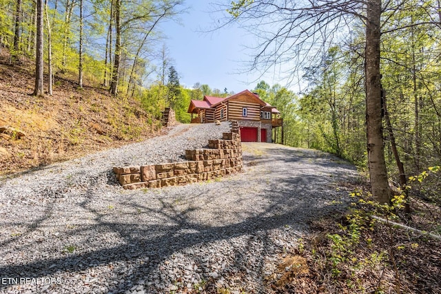 view of street with gravel driveway