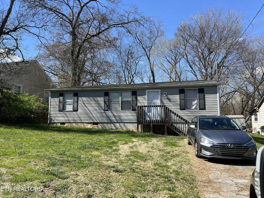 view of front of house with a front yard and crawl space