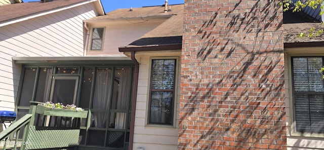 view of exterior entry featuring brick siding