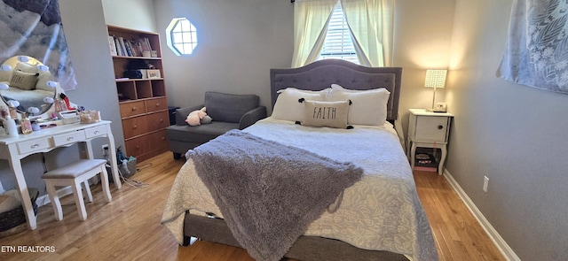 bedroom featuring light wood-type flooring and baseboards