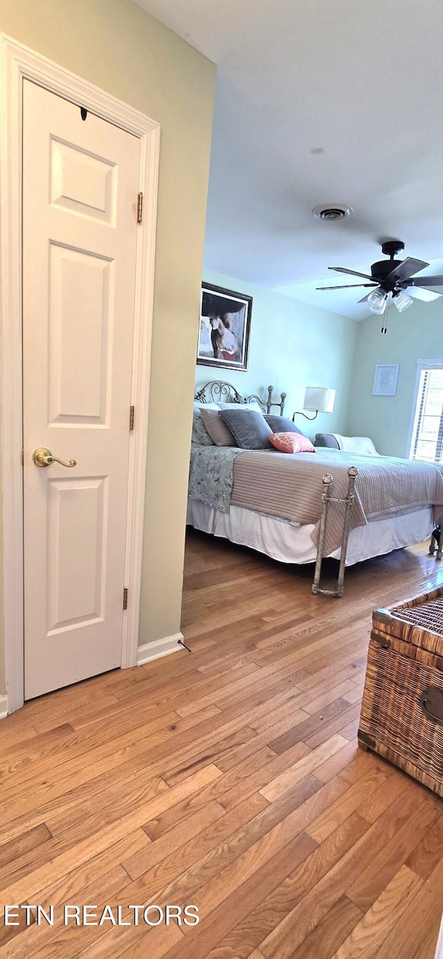 bedroom with visible vents, light wood-style flooring, and ceiling fan