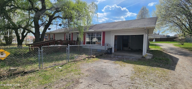 view of front of home with fence, driveway, and a garage