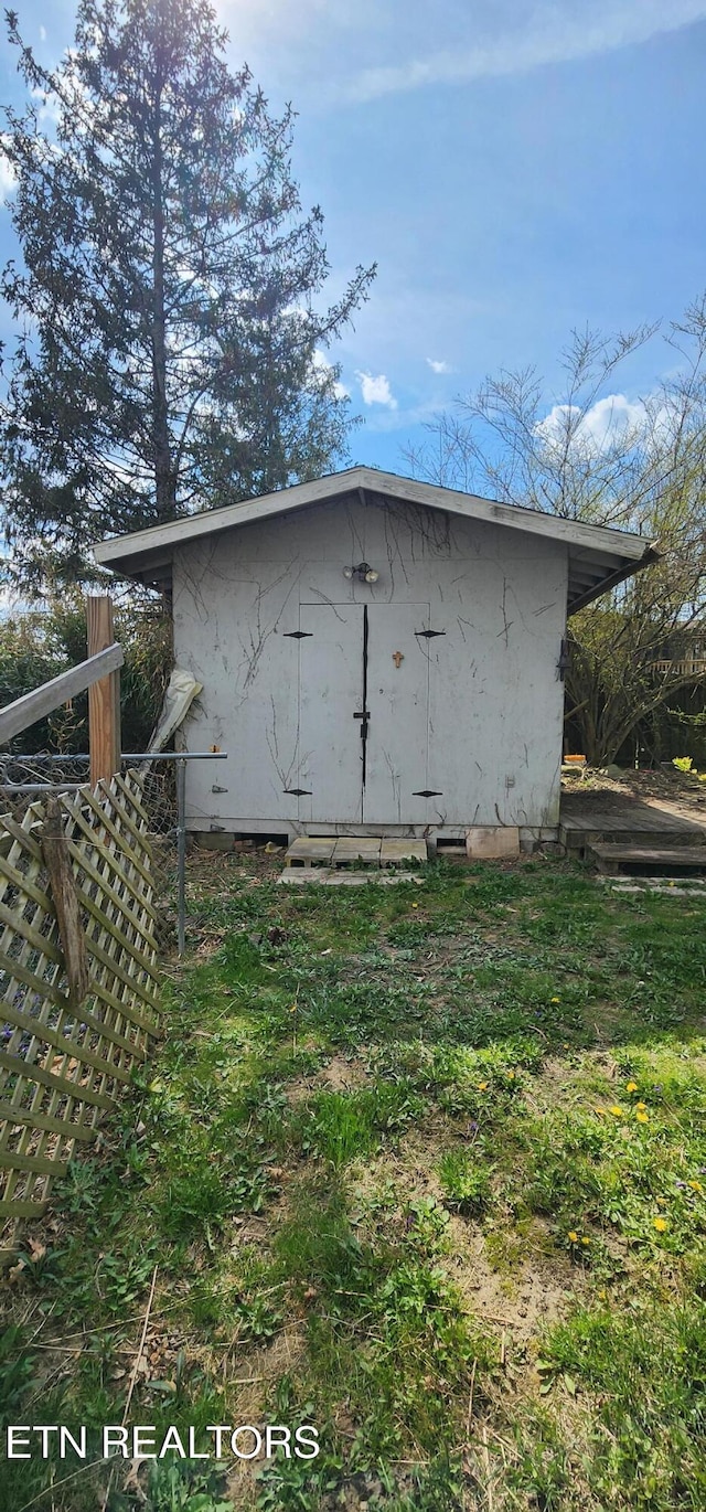 view of shed featuring fence