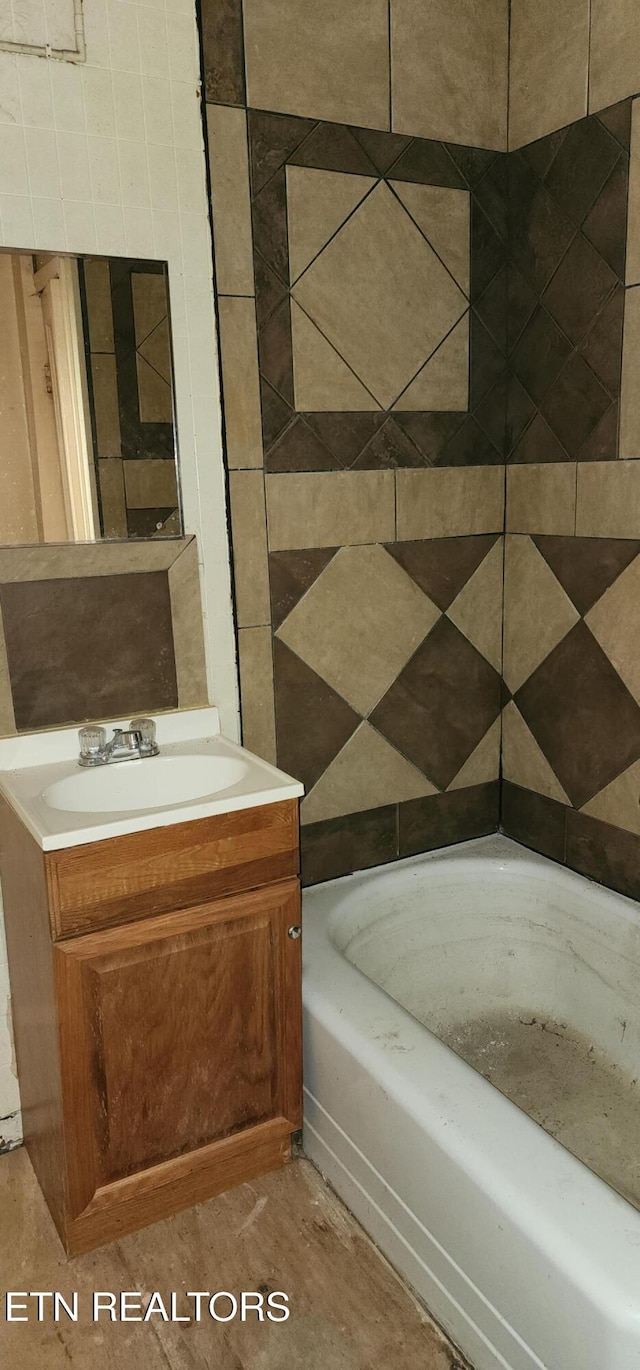 full bath featuring a bathing tub and vanity