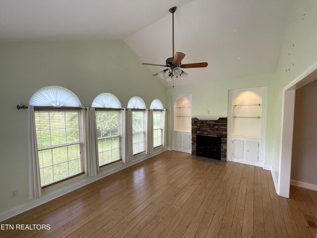 3618 Audrey Jo Ln, Sevierville, TN 37876 - unfurnished living room featuring ceiling fan, wood finished floors, high vaulted ceiling, a fireplace, and built in features