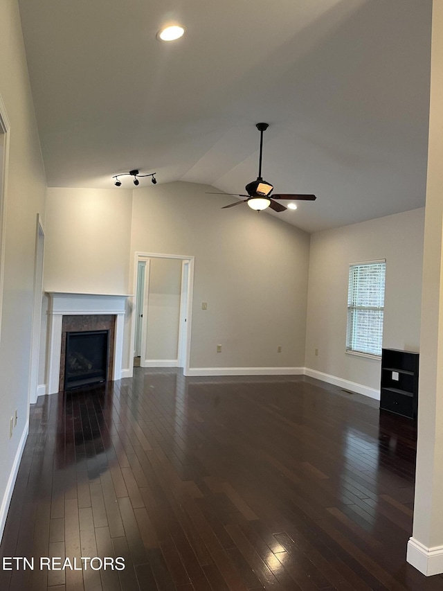 891 Forgety Rd, Jefferson City, TN 37760 - unfurnished living room with a ceiling fan, a tiled fireplace, dark wood-style flooring, vaulted ceiling, and recessed lighting