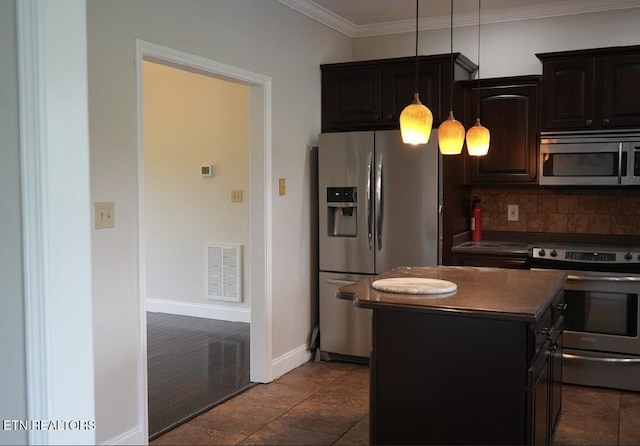 891 Forgety Rd, Jefferson City, TN 37760 - kitchen featuring appliances with stainless steel finishes, dark countertops, decorative backsplash, a kitchen island, and crown molding