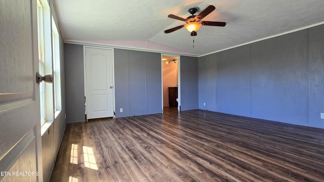 unfurnished bedroom featuring a ceiling fan, a closet, dark wood-style floors, and lofted ceiling