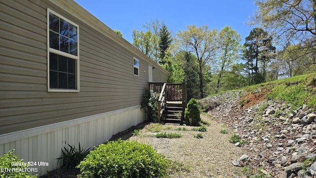 view of side of home featuring stairs