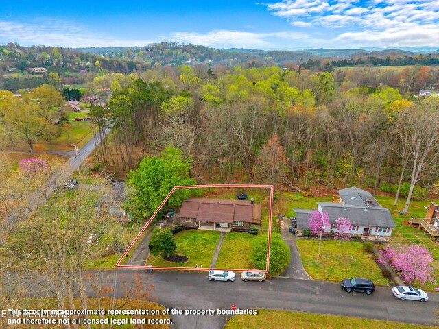 aerial view featuring a wooded view