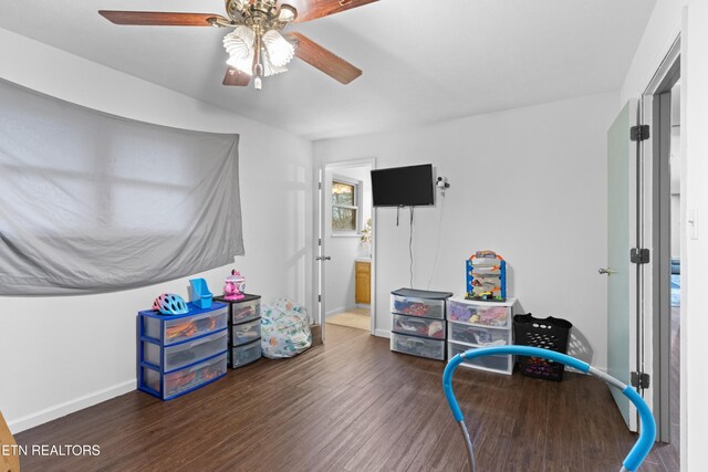 game room with baseboards, ceiling fan, and wood finished floors