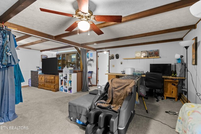 living area featuring carpet floors, a textured ceiling, a ceiling fan, and beam ceiling