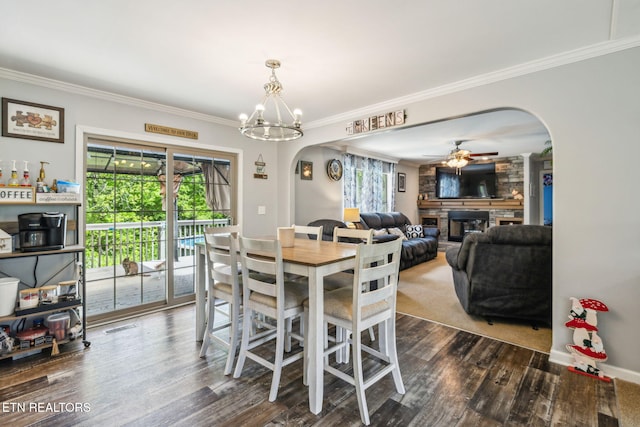 160 Walnut Ln, Rutledge, TN 37861 - dining space with crown molding, dark wood-style flooring, a fireplace, and arched walkways