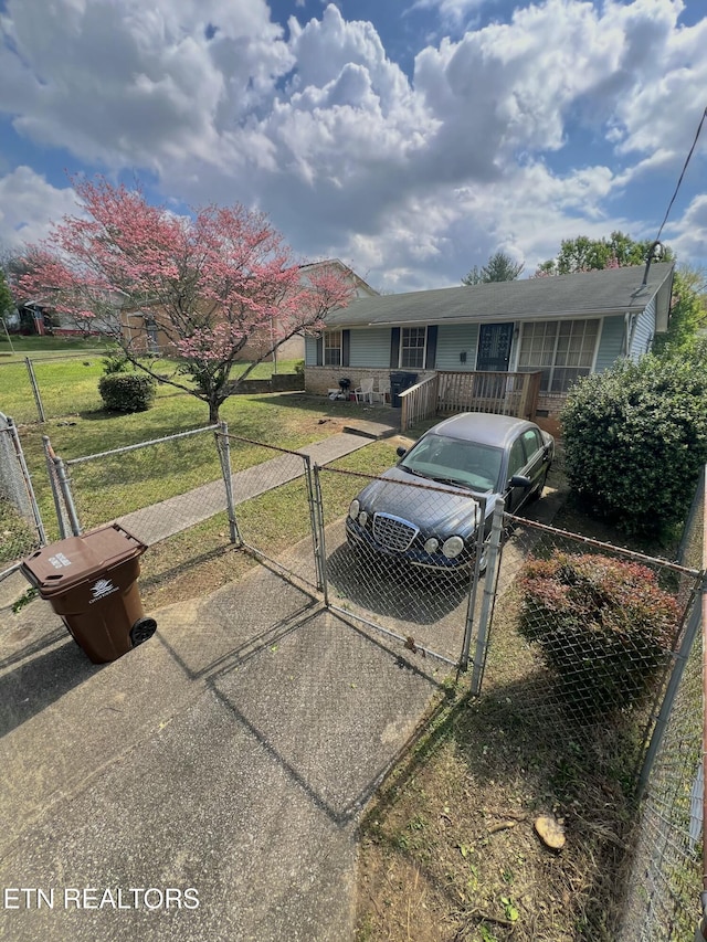 ranch-style home featuring a gate and a fenced front yard