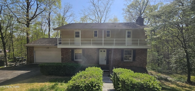 115 Morgan Rd, Oak Ridge, TN 37830 - view of front of house featuring brick siding, a chimney, a garage, and a balcony