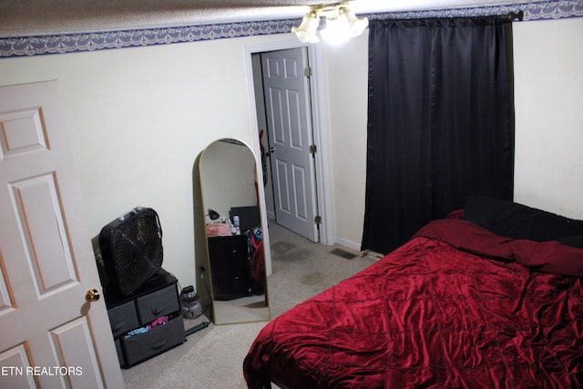 carpeted bedroom featuring visible vents