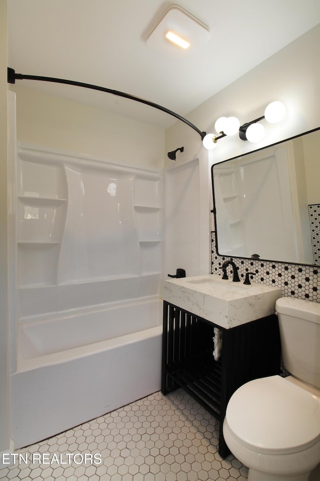 full bathroom featuring toilet, vanity, tile patterned flooring, and bathing tub / shower combination