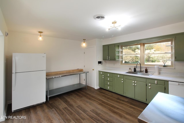 kitchen with light countertops, visible vents, white appliances, a sink, and green cabinetry
