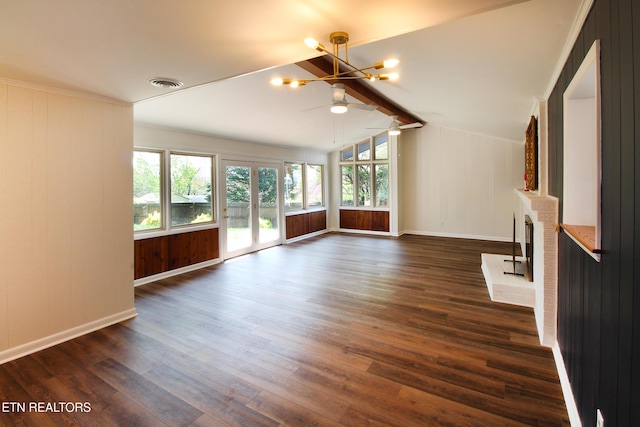 unfurnished living room featuring plenty of natural light, vaulted ceiling with beams, visible vents, and dark wood finished floors